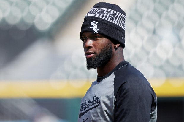 White Sox outfielder Luis Robert Jr. talks with teammates during a team workout at Guaranteed Rate Field Wednesday, March 27, 2024, in Chicago. (John J. Kim/Chicago Tribune)