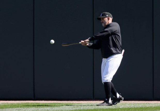 White Sox manager Pedro Grifol hits a ball back to the infield during a team workout at Guaranteed Rate Field Wednesday, March 27, 2024, in Chicago. (John J. Kim/Chicago Tribune)