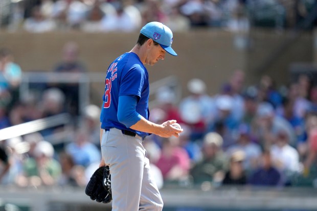 Cubs starting pitcher Kyle Hendricks looks at a new baseball after giving up a two-run home run against the Diamondbacks during a Cactus League game on March 8, 2024, in Scottsdale, Ariz. (Ross D. Franklin/AP)
