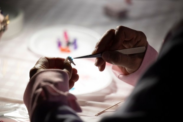 A member of the Windy City Collectors decorates shoes during a meeting at Russell's Barbecue in Elmwood Park on Nov. 9, 2023. (Trent Sprague/Chicago Tribune)