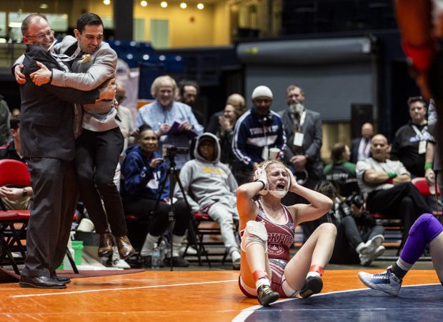 Lockport's Claudia Heeney cries with joy after defeating Collinsville's Taylor Dawson in the girls wrestling championship match at 130 pound at Grossinger Motors Arena in Bloomington on Saturday, Feb. 24, 2024. (Vincent D. Johnson / Daily Southtown)