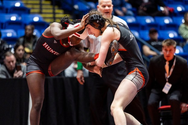 Kaneland's Angelina Gochis holds onto the leg of Huntley's Janiah Slaughter in the girls wrestling championship match in the 105 pound at Grossinger Motors Arena in Bloomington on Saturday, Feb. 24, 2024. (Vincent D. Johnson / Daily Southtown)