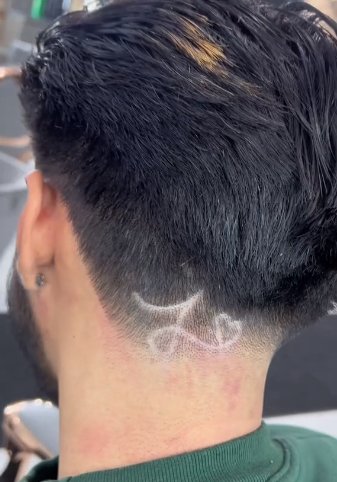 Elgin barber Emilio Chavez has added a small touch to the back of his customer's transformative haircut, as captured in a TikTok video. (Emilio Chavez)