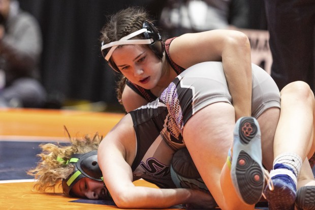 Batavia's Sydney Perry, top, wrestles against El Paso-Gridley's Valerie Hamilton during the 145-pound state championship match in Bloomington on Saturday, Feb. 25, 2023.