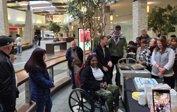 Denise Richardson, center, general manager of the Spring Hill Mall in West Dundee/Carpentersville, greets visitors Friday on the shopping center's final day before permanent closure. They had a cake to celebrate the memories of those who attended, including many people who once worked, met or shopped at the mall. (Gloria Casas/The Courier-News)