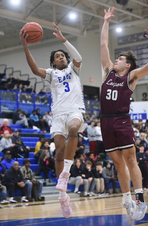 Lincoln-Way East's Brenden Sanders (30) drives to the basket against Lockport's Evan Dziadkowiec (30) during a SouthWest Suburban Blue game in Frankfort on Friday, Jan. 20, 2023.