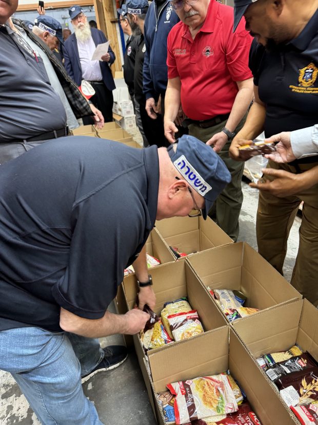 The Rev. Phil Zilinski helps pack boxes to be shipped to those in need around Israel during a trip to the country he took as part of