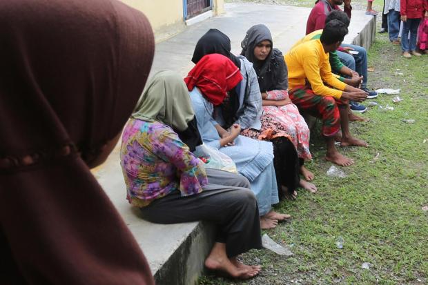 Ethnic Rohingya people rescued from their capsized boat rest at a local government building in Samatiga, Aceh province, Indonesia, Wednesday, March 20, 2024. A wooden boat carrying dozens of Rohingya Muslims capsized about 16 miles (25 Kilometers) from the coastline of Kuala Bubon beach in Indonesia's northernmost province of Aceh on Wednesday. (AP Photo)