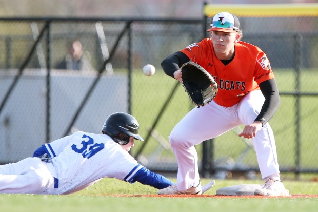 Vernon Hills' Dylan Sherwin (39), getting back to first before Libertyville's Josh Holst (orange), makes the catch, during the baseball game on Friday, April 21, 2023, in Vernon Hills. (Mark Ukena for Pioneer Press)