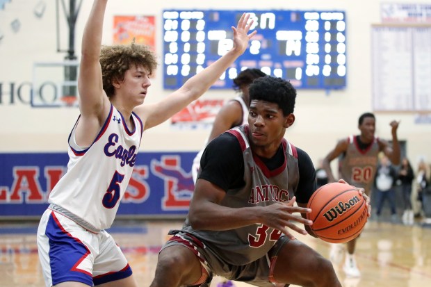 Antioch's Marshall Gehrke (34), trying to get around Lakes' Jaden Jackson (5), during the basketball game on Friday, December 1, 2023, in Lake Villa. (Mark Ukena for Lake County News-Sun)