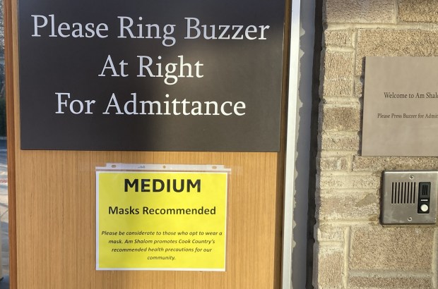 Four years after the U.S. government declared a national health emergency because of the coronavirus pandemic, signs still make suggestions about wearing a mask. (Steve Sadin/Lake County News-Sun)