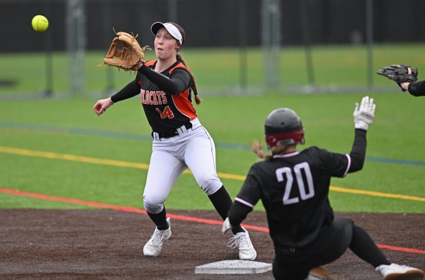 Libertyville's Zoe Kinsella (14) takes a throw, but is too late to catch Antioch's Samanth Hillner (20) at 2nd base during the 2nd inning of Wednesday's game, March 13, 2024. Antioch won the game, 15-1, after 5 innings. (Brian O'Mahoney for the News-Sun)