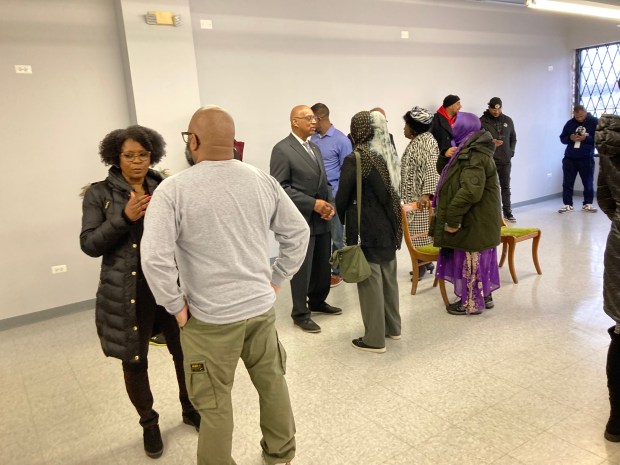 State Sen. Adriane Johnson (far let), D-Buffalo Grove, North Chicago Mayor Leon Rockingham, Jr. (third from left) and Lake County Board member Mary Ross Cunningham (7th from left) talk to people inside the future home of the Harvest Market in Waukegan. (Steve Sadin/Lake County News-Sun)