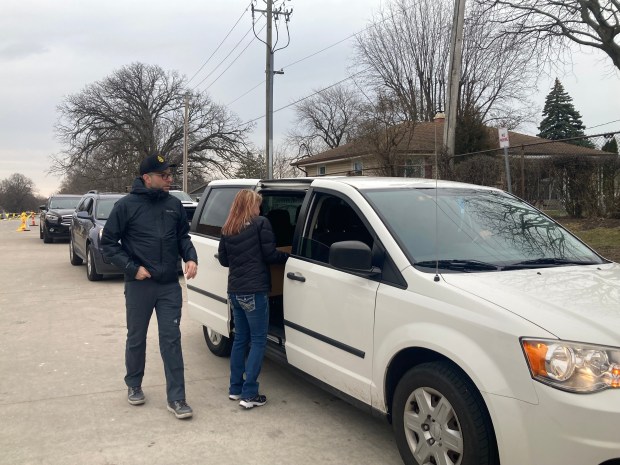 Cars line up for a spring break food distribution. (Steve Sadin/Lake County News-Sun)