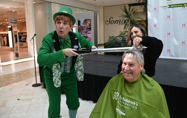 Can you say oversized scissors for fun? From left to right, leprechaun Erin Go Bragh, Hawthorn Mall's Tricoci Salon & Spa Stylist Ashley D'Amico of Long Grove and shavee Don Higginbottom of Lindenhurst share a photo opportunity on March 23, 2024 at Rock the Bald with Hawthorn at Hawthorn Mall in Vernon Hills. (Karie Angell Luc/Lake County News-Sun)