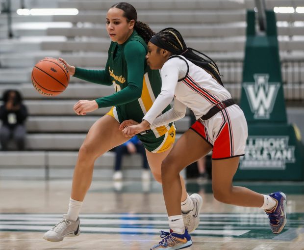 Waubonsie Valley's Danyella Mporokoso (10) dribbles down court during the Class 4A Illinois Wesleyan Supersectional against Alton in Bloomington on Monday, Feb. 26 2024. (Troy Stolt for the Aurora Beacon News)