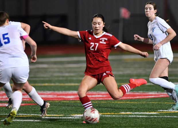 Naperville Central's Malia Shen (27) takes a shot while surrounded by Burlington Central defenders during a match Wednesday, March 13, 2024, in Naperville.(Jon Cunningham/for The Naperville Sun)