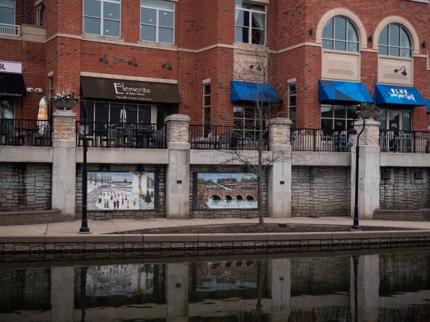 The "Streaming History" series lines the Naperville Riverwalk. The series, pictured Mar. 1, 2024, was created by Debora Duran-Geiger. It is one of dozens of pieces part of the Century Walk collection. (Tess Kenny/Naperville Sun)