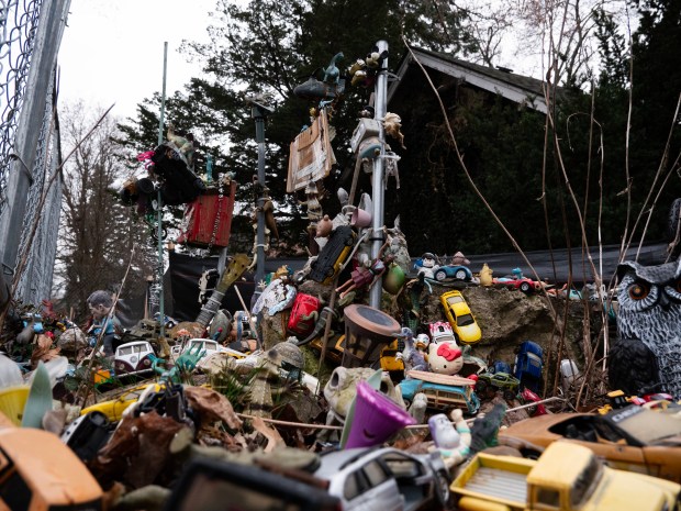 The Magic Rock in Naperville, a collection of donated trinkets and toys glued together in a display, has sat in the front lawn of 711 North Brainard Street for years. Now, however, as the property faces demolition, the fate of the local landmark is up in the air. (Tess Kenny/Naperville Sun)