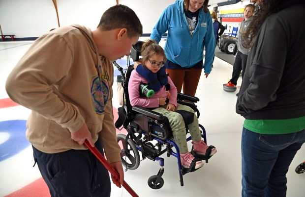 From left, Max Osterman, 13, an eighth-grader from Northbrook and Shannon Arnspong of Northbrook, are here to experience curling at the Chicago Curling Club on March 1, 2024 in Northbrook (555 Dundee Road). (Karie Angell Luc/Pioneer Press)