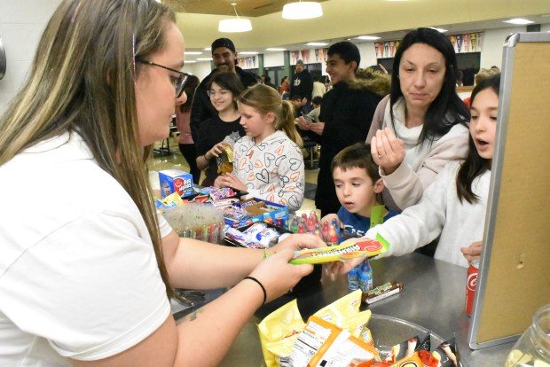 PTO volunteer Katie Smith works the popular candy counter Friday, March 1 at Gower Middle School. (Jesse Wright)