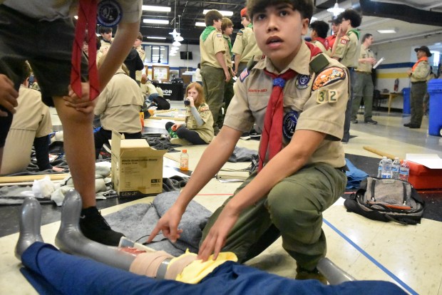 Alexis Aleman out of Berwyn's Troop 32 treats a bloody wound on a dummy Saturday morning as part of a scouting first aid competition. (Jesse Wright)