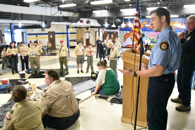 Spencer Bourn, an Explorer Scout with the fire and EMS program, talks to scouts Saturday about the advantages of getting into a specialty scouting program if they're interested in first aid training. (Jesse Wright)