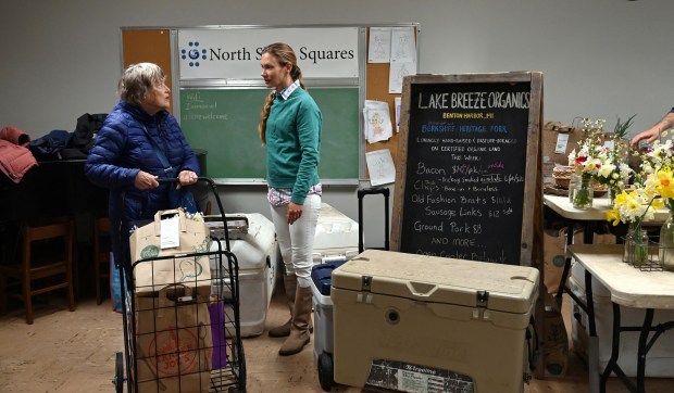 From left to right, Vikki Proctor of Evanston, a shopper, is also the mother in law of (right) vendor Danika Murray of Benton Harbor, Michigan. Murray is also co-owner of Lake Breeze Organics. Taken downstairs of Evanston's Community Winter Indoor Farmers' Market at Immanuel Lutheran Church in Evanston (616 Lake St.) in Evanston on March 16, 2023. (Karie Angell Luc/for the Pioneer Press)