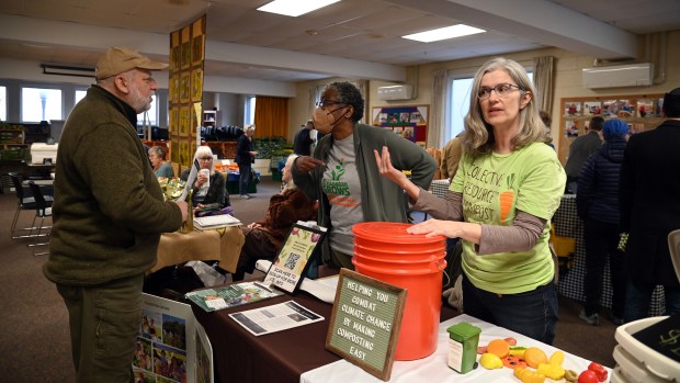 From left to right, Robert Klein of Skokie, Jocelyn Mallard of Evanston, representing the University of Illinois Master Gardeners program and Evanston Grows, a 501c3 organization and Mary Beth Schaye of Evanston, representing Collective Resource Compost Cooperative, converse at Evanston's Community Winter Indoor Farmers' Market at Immanuel Lutheran Church in Evanston (616 Lake St.) in Evanston on March 16, 2023. (Karie Angell Luc/for the Pioneer Press)