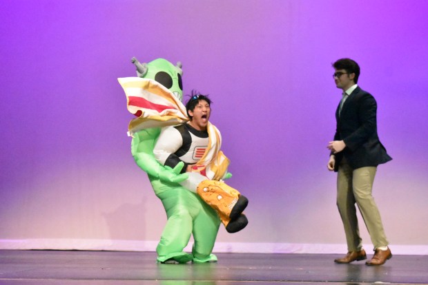 Senior Mike Wyckoff hits the beach with an alien in tow and, at right, his escort, Drew Grech, in the swimsuit competition portion of the Mr. LT talent show. (Jesse Wright)