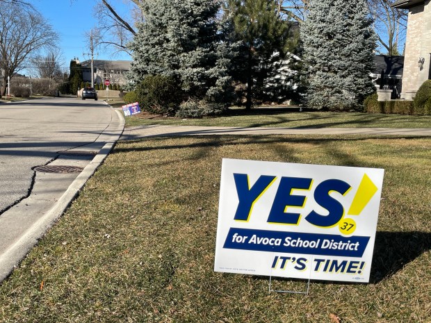 A sign in favor of a referendum proposing to close one school and expand another in Avoca School District 37 stands next door to another opposing the plan on Sherwood Road in Glenview. (Phil Rockrohr)