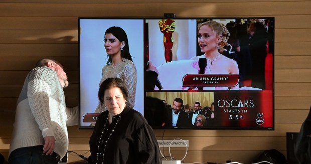 Second from left, Jennifer Maxwell Parkinson of Glencoe, president of WLC Northshore Woman's Library Club helps to make sure the monitor is showing the live broadcast of the Oscars at the annual WLC annual Oscars Viewing Party at Writers Theatre in Glencoe on March 10, 2024. (Karie Angell Luc/Pioneer Press)