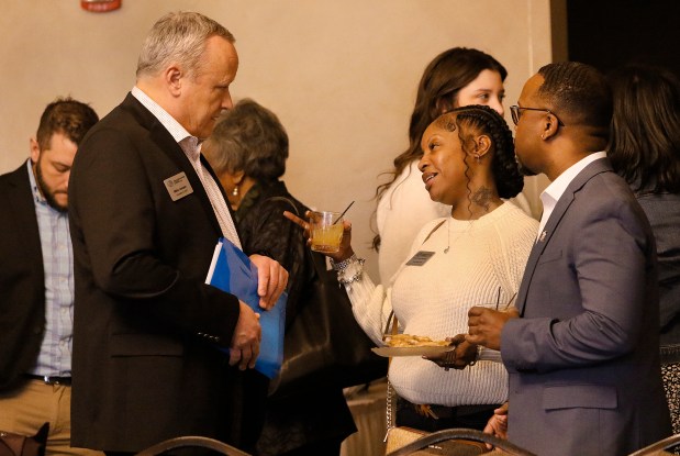 Boys and Girls Clubs of Northwest Indiana President and CEO Mike Jessen (left) greets Sheria Givens-Pearson and Dwayne Washington during the ceremony honoring Youth of the Year candidates from clubs in Lake and Porter counties on Thursday, February 29, 2024. (John Smierciak for the Post-Tribune)