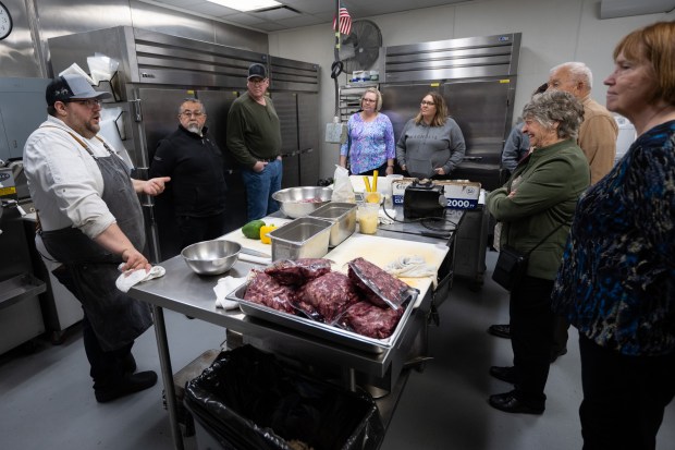 Provecho latin Provisions sous chef Jarett Nelson leads members of the tourism industry through the restaurant's kitchen during a stop on the Heartland Familiarization tour in Crown Point on Tuesday, March 5, 2024. (Kyle Telechan/for the Post-Tribune)