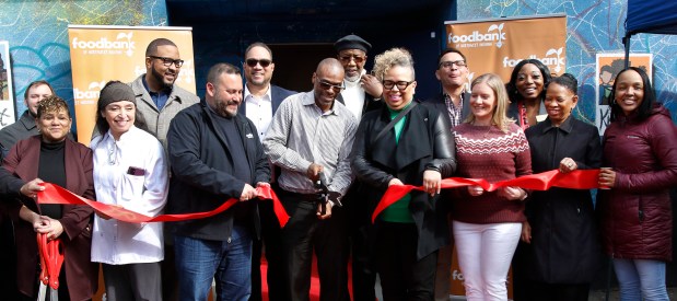 Pastor Curtis Whittaker (center) cuts the ribbon during the grand opening ceremony at Faith Farms and Orchard in Gary. The Faith Fresh Frozen program is a new initiative aimed at promoting healthier lifestyles and fostering community well-being in the city. The ground breaking took place on Thursday, March 21, 2024. (John Smierciak/for the Post Tribune)