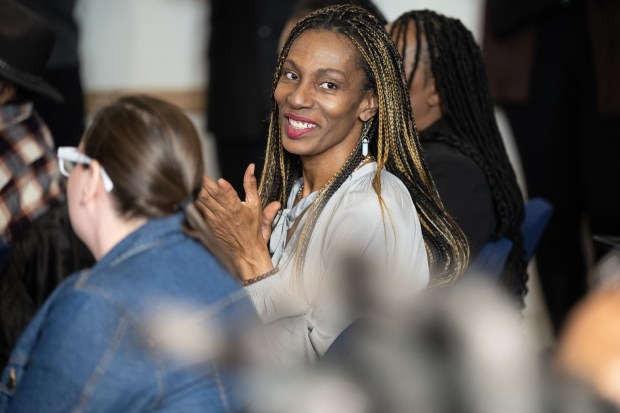 Trail My Mix LLC owner Angel Knight, who received a $10,000 grant for her business, applauds during a network social and award ceremony in Gary to celebrate recipients of American Rescue Plan Act grants on Wednesday, March 6, 2024. (Kyle Telechan/for the Post-Tribune)