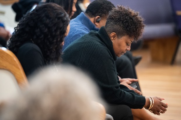 Family members of Ralph and Donald Kinsey, members of the Gary blues group The Kinsey Report, bow their heads in prayer during a memorial service in the Kinsey brothers' honor on Saturday, March 2, 2024 in Gary. (Kyle Telechan/for the Post-Tribune)