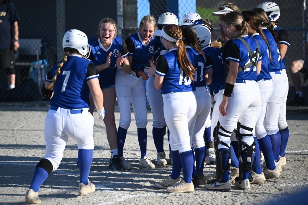 Boone Grove players welcome teammate Mercedes Szakacs to the home plate after a home run against Bishop Noll on Thursday, April 13, 2023. (Kyle Telechan for the Post-Tribune)