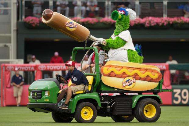 FILE - The Phillie Phanatic comes out with his Hot Dog Launcher during the fifth inning of a baseball game between the Atlanta Braves and the Philadelphia Phillies, Monday, July 4, 2016, in Philadelphia. For more than a quarter-century, Phillies fans thought dollar hot dog night was the best ballpark promotion but the team has now decided it was the wurst. (AP Photo/Chris Szagola, File)