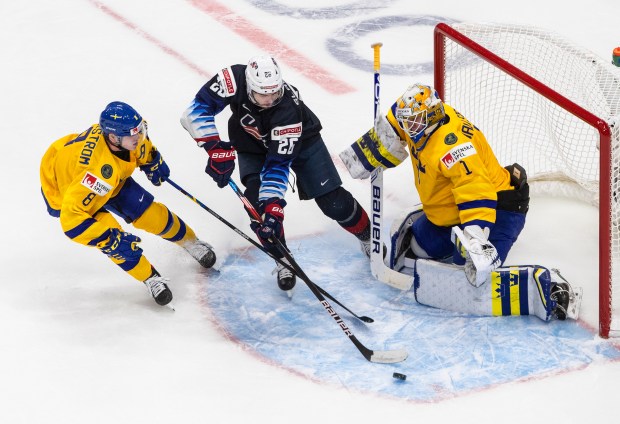 Sweden goalie Jesper Wallstedt makes a save against the United States' Landon Slaggert during aWorld Junior Championship game Dec. 31, 2020, in Edmonton, Alberta. (Jason Franson/AP)