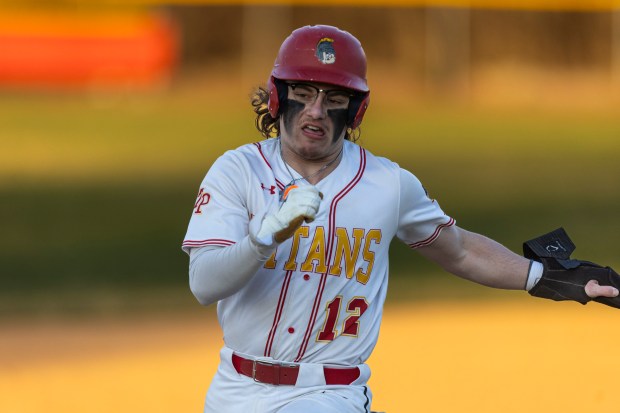 Tinley Park's Austin Kirnbauer hustles into third base against Marian Catholic during a nonconference game in Tinley Park on Wednesday, March 20, 2024. (Vincent D. Johnson/for the Daily Southtown)