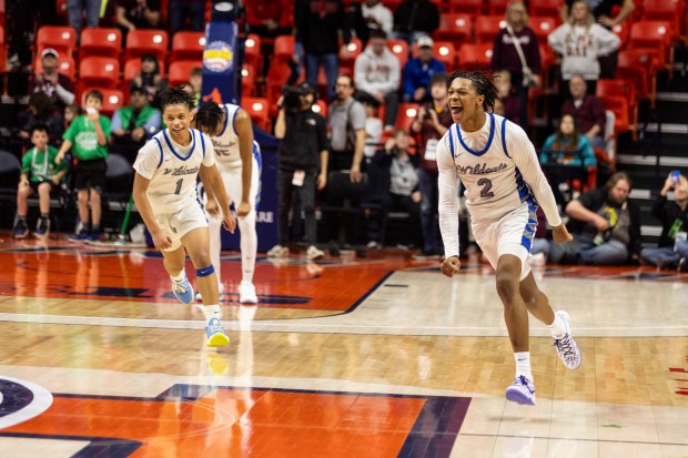 Phillips' Amari Edwards (1) and Lawrence Horton (2) run across the court after beating Benton 54-47 to win the Class 2A state championship game at State Farm Center in Champaign on Saturday, March 9, 2024. (Vincent D. Johnson/for the Daily Southtown)