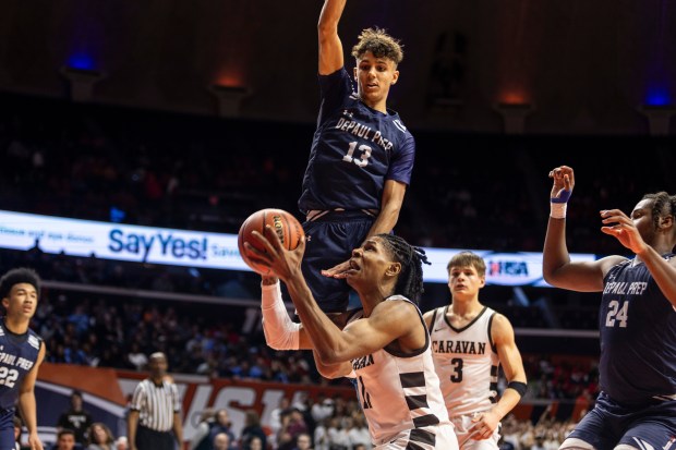 DePaul Prep's Makai Kvamme (13) elevates in an attempt to block Mount Carmel's Lee Marks' shot during the Class 3A state championship game at State Farm Center in Champaign on Saturday, March 9, 2024. (Vincent D. Johnson/for the Daily Southtown)