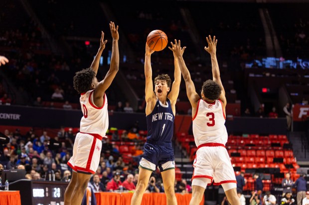 Homewood-Flossmoor's Jayden Tyler (0) and Caleb Chavers (3) try to block a jump pass from New Trier's Christopher Kirkpatrick (1) during the Class 4A state semifinals at the State Farm Center in Champaign on Friday, March 8, 2024. (Vincent D. Johnson/for the Daily Southtown)