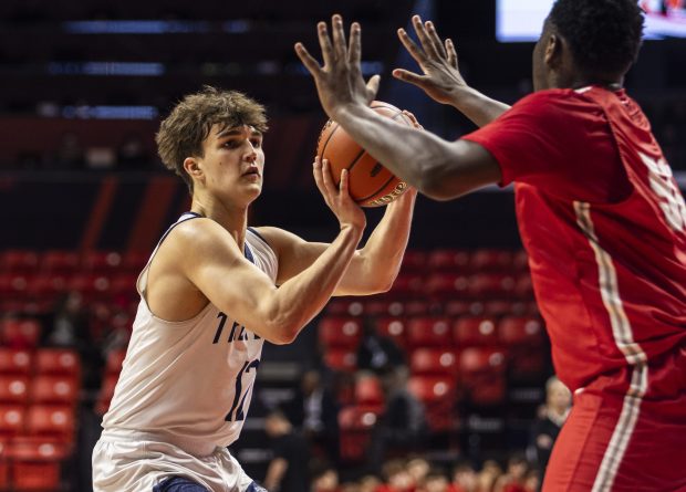 New Trier's William Leemaster (12) pulls up for a shot against Palatine during the Class 4A third place game at State Farm Center in Champaign on Friday, March 8, 2024. (Vincent D. Johnson/for the Pioneer Press)