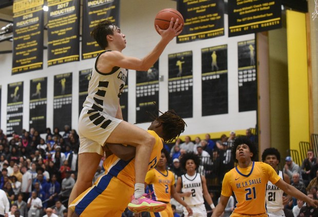 Mount Carmel's Angelo Ciaravino (33) drives to the basket against De La Salle's Remi Edwards (13) during the Class 3A Hinsdale South Sectional final Friday, March 1, 2024 in Darien, IL. (Steve Johnston/Daily Southtown)