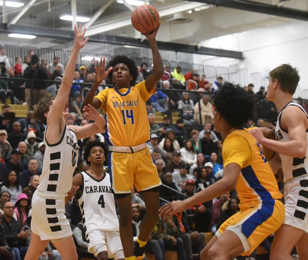 De La Salle's Charles Barnes (14) floats up a shot against Mount Carmel during the Class 3A Hinsdale South Sectional final Friday, March 1, 2024 in Darien, IL. (Steve Johnston/Daily Southtown)