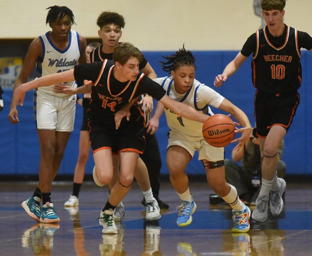 Beecher's Jack Hayhurst (14) and Phillips' Amari Edwards (1) chase down the loose ball during the Class 2A Joliet Central Supersectional Monday, March 4, 2024 in Joliet, IL. (Steve Johnston/Daily Southtown)