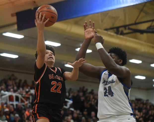 Beecher's Zackary Johnson (22) tries to lay in a basket against Phillips' Claude Mpouma (24) during the Class 2A Joliet Central Supersectional Monday, March 4, 2024 in Joliet, IL. (Steve Johnston/Daily Southtown)