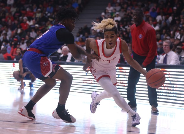 Homewood-Flossmoor point guard Gianni Cobb (1) pushes past Curie guard Carlos Harris (2) during the Class 4A UIC Supersectional at Credit Union 1 Arena in Chicago on Monday, March 4, 2024. (Trent Sprague/for the Daily Southtown)